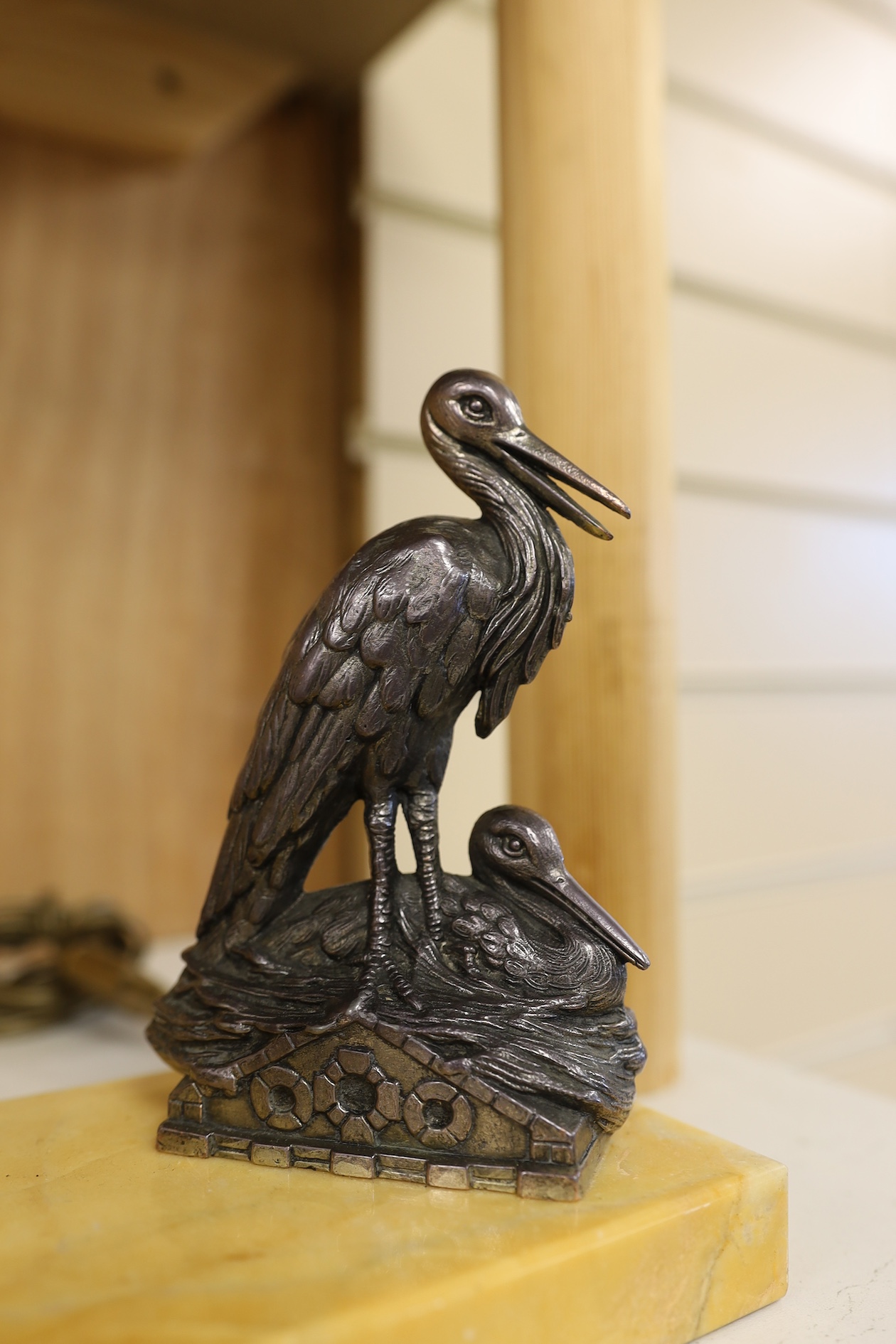 Two Art Deco lamps, one with a model of a dog the other of two pelicans, both with circular glass shades, largest 20cm wide. Condition - fair